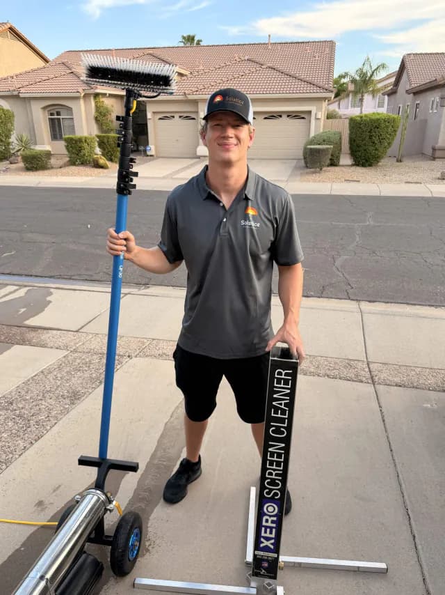 Ben of Solstice Window Cleaning holding a water-fed pole and screen-cleaning equipment