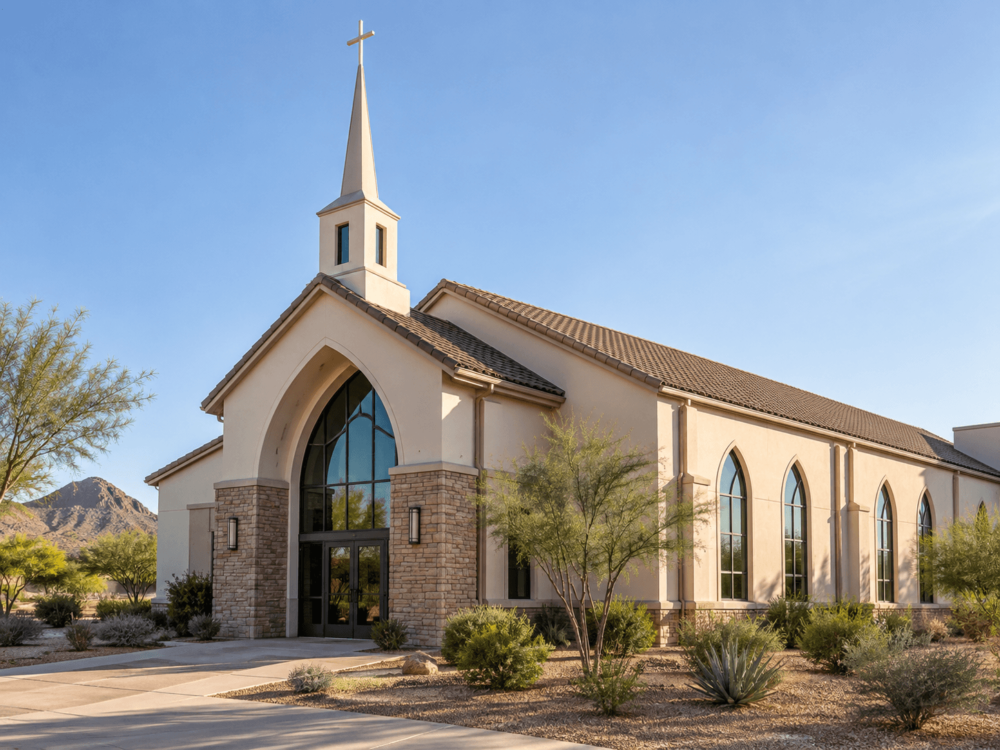 Phoenix-area church with tall arched windows and desert landscaping.