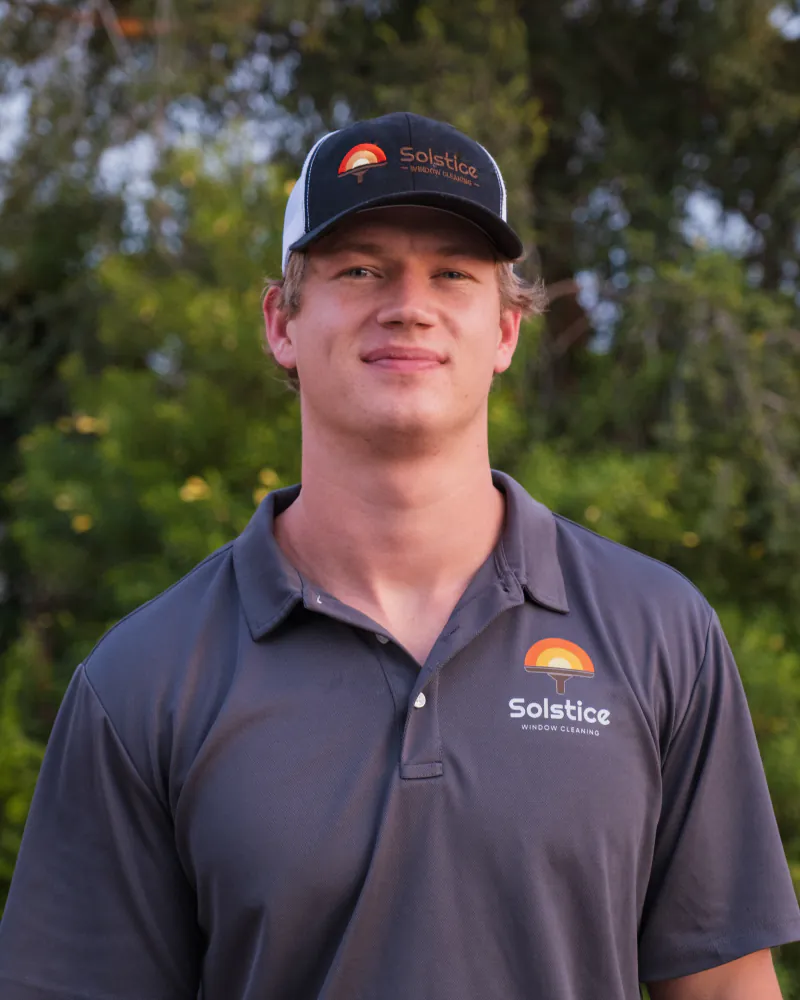 Ben Hislop, owner of Solstice Window Cleaning, in a branded polo and hat